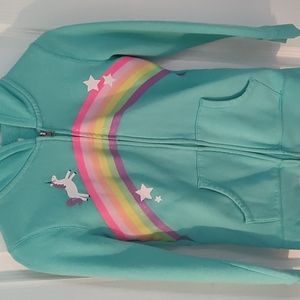Teal hoodie sweatshirt with unicorn print and rainbow Infront of the sweatshirt.